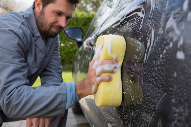 istock Auto service staff washing a car with sponge 864591264