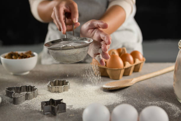 istock Woman staining flour in sieve 864594762