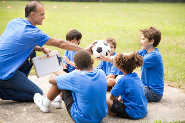 istock Soccer team coach explains next play to his children's team. 864597666