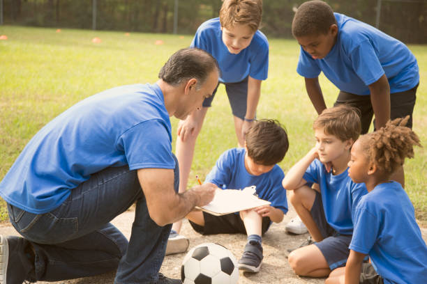 istock Soccer team coach explains next play to his children's team. 864598398