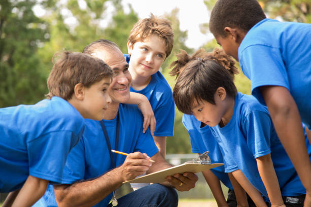 istock Soccer team coach explains next play to his children's team. 864598794