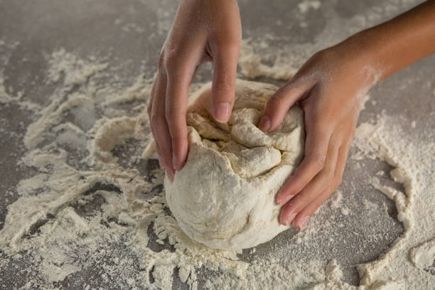 istock Woman kneading a dough 864599408