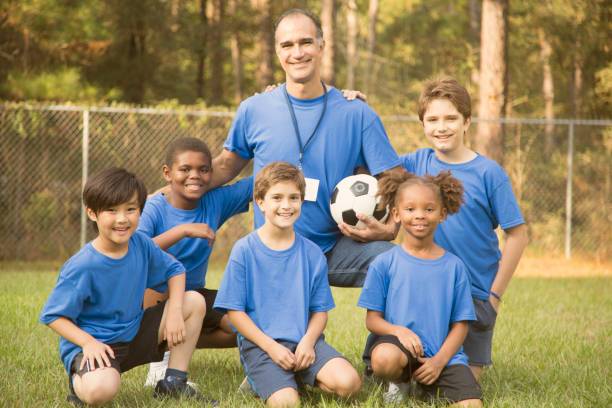 istock Child's soccer team with coach. 864600308