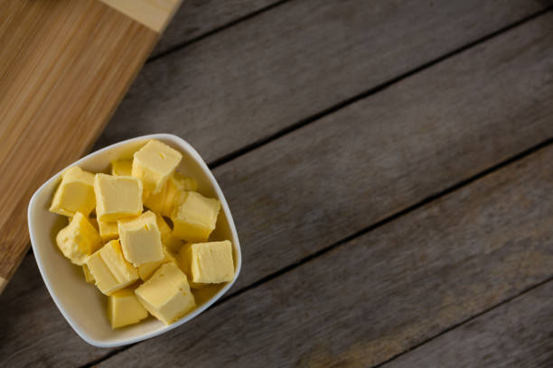 istock Cheese cubes in a bowl on wooden table 864600608