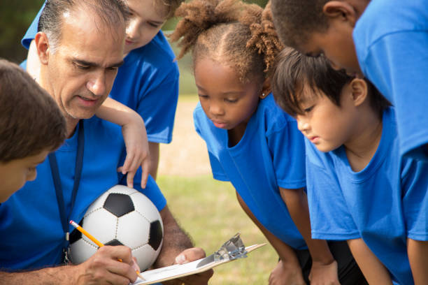 istock Soccer team coach explains next play to his children's team. 864600844