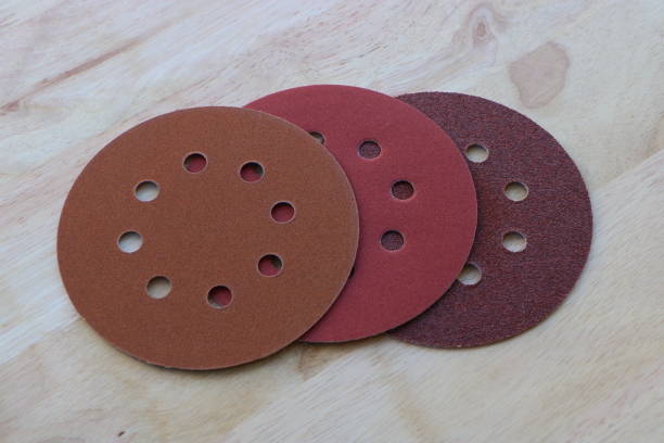 Circular sanding pads on wooden background stock photo