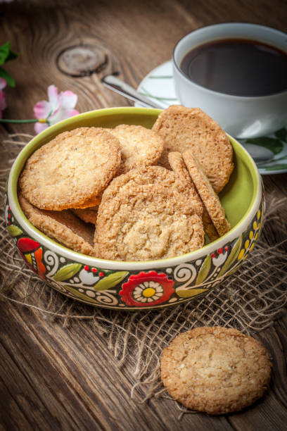 istock Stack of freshly baked oat biscuits in a bowl. 864602314
