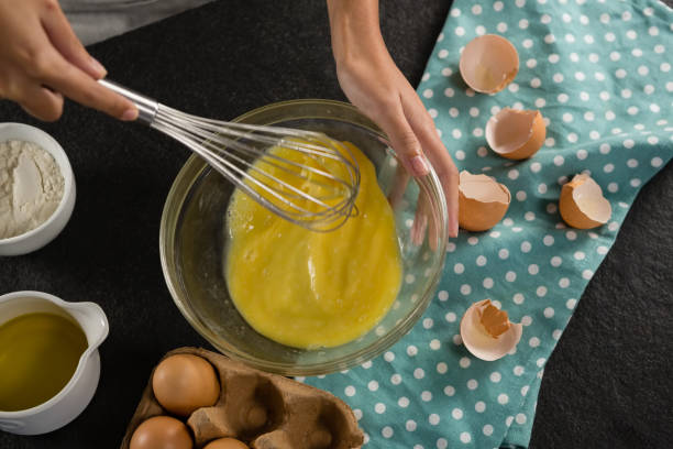 istock Woman beating eggs with a whisk in a bowl 864603580