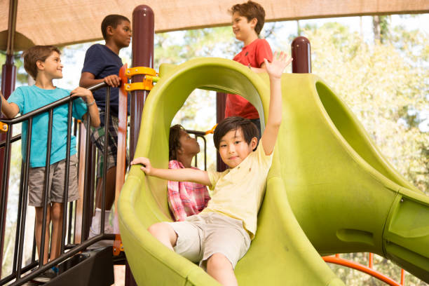 istock Multi-ethnic group of school children playing on school playground. 864603758