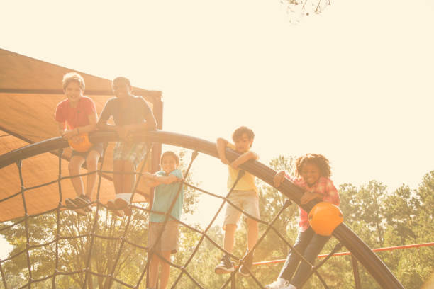 istock Multi-ethnic group of school children playing on school playground. 864603932