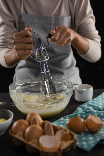 istock Woman whisking batter in a bowl 864603990