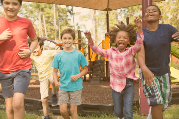 istock Multi-ethnic group of school children running on school playground. 864606790