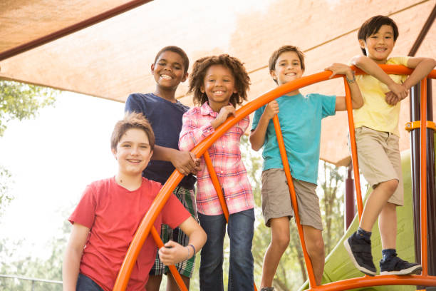 istock Multi-ethnic group of school children playing on school playground. 864607368