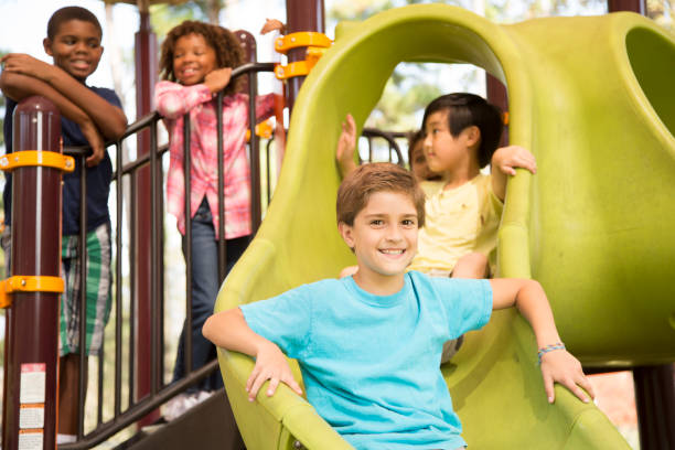 istock Multi-ethnic group of school children playing on school playground. 864608152