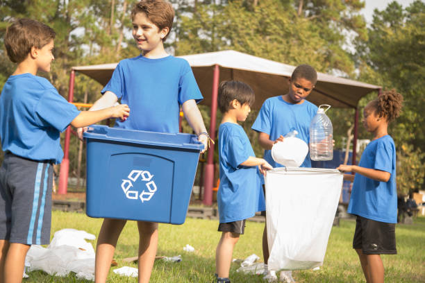 istock Multi-ethnic group of school children recycling at park. 864615342