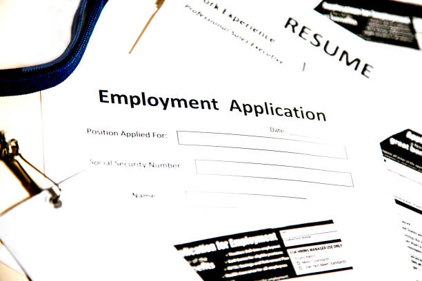 istock Job fair table with employment applications, resumes. 864618894