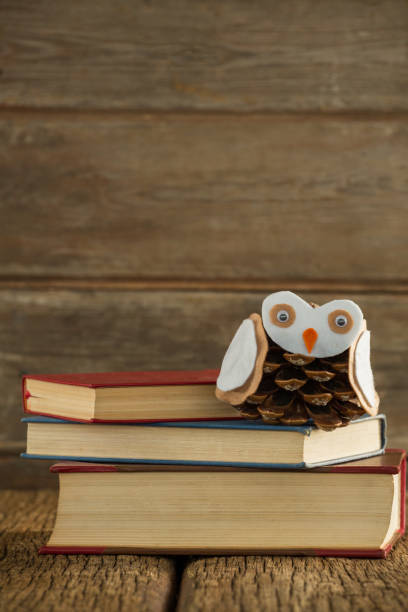 istock Book stack and christmas decoration on wooden plank 864619234