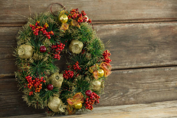 istock Christmas wreath against wooden surface 864620342