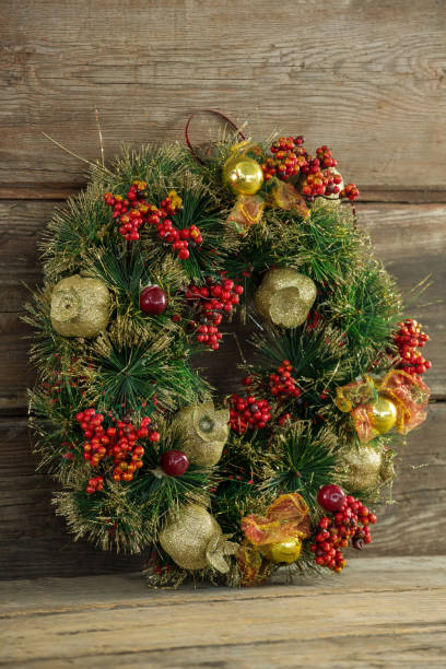 istock Christmas wreath against wooden background 864625036