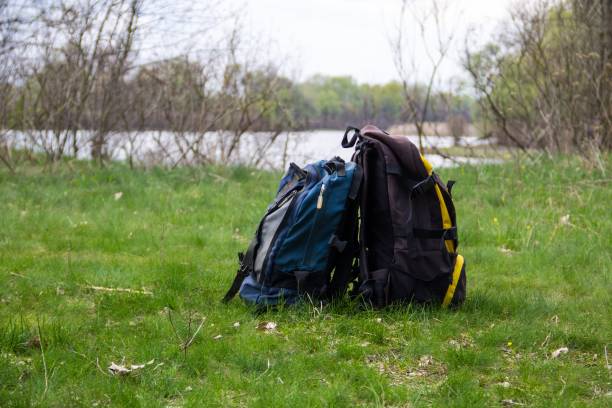 istock Two touristic backpacks on the riverbank. Hike concept 864631106