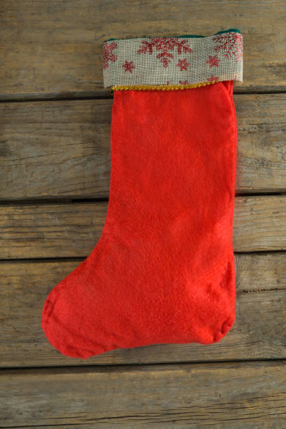 istock Christmas stocking on wooden wall 864637772
