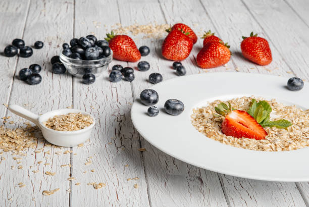istock fresh Blueberries , strawberries and oatmeal on table 864638198