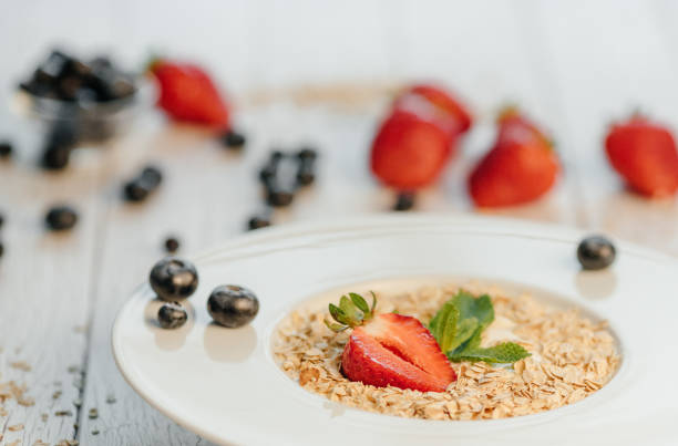 istock fresh Blueberries , strawberries and oatmeal on table 864638266