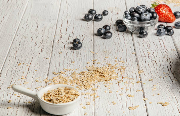 istock fresh Blueberries , strawberries and oatmeal on table 864638294