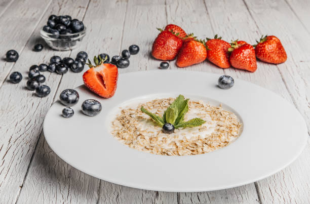 istock fresh Blueberries , strawberries and oatmeal on table 864638320