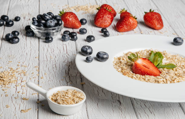 istock fresh Blueberries , strawberries and oatmeal on table 864638414