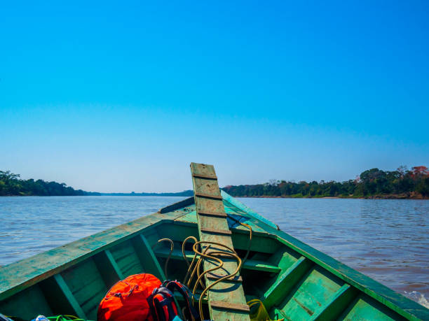 istock Travelling through Madre de Dios river in a wood boat, medium shot 864645284