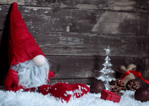 istock Winter Holiday background- Christmas dwarf on snow 864645986