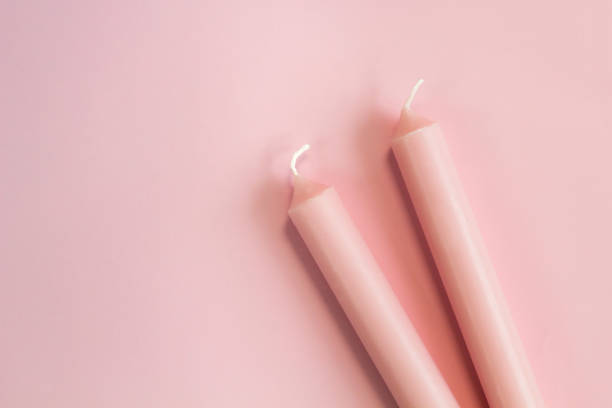 istock pink pastel candles on pink pastel background 864648622