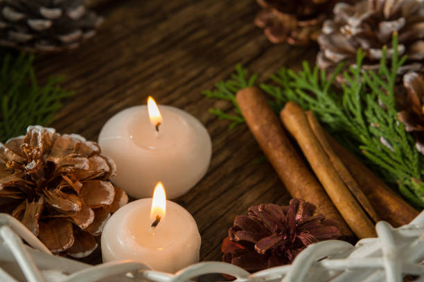 istock High angle view of pine cones with illuminated candles and wreath 864663996