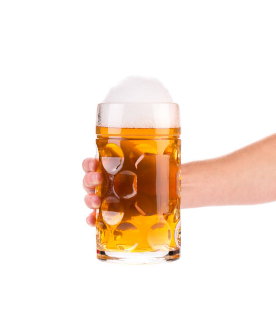 istock Frosty glass of beer with hand. 864665758