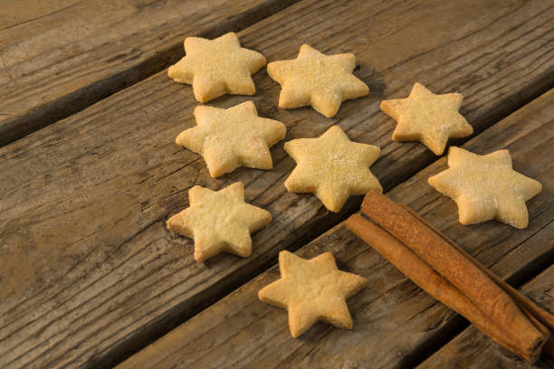 Close up of Christmas tree made with star shape cookie and cinnamon stick
