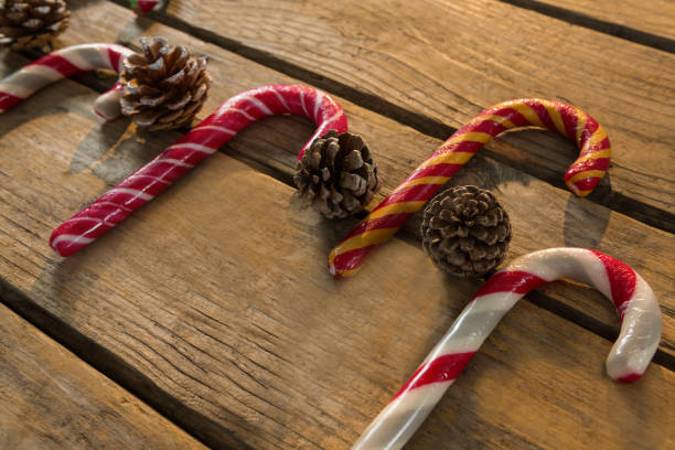 istock Colorful candy canes with pine cones 864674242
