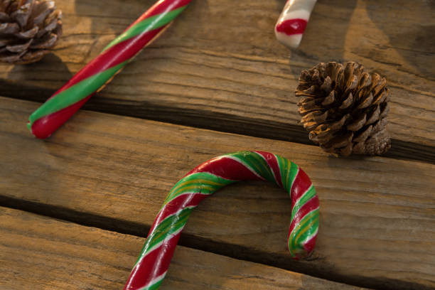istock Close up of candy canes and pine cones on table 864676290