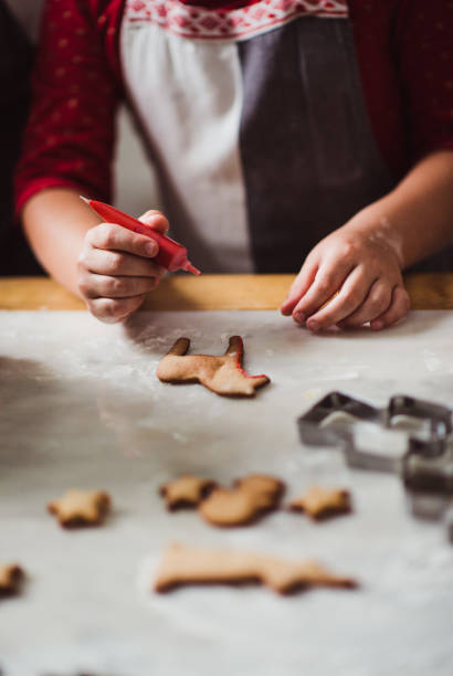 istock Little girl baking gingerbread cookies 864679946