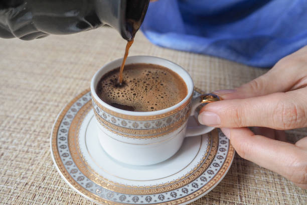 istock Hand holding a cup of coffee. 864691590