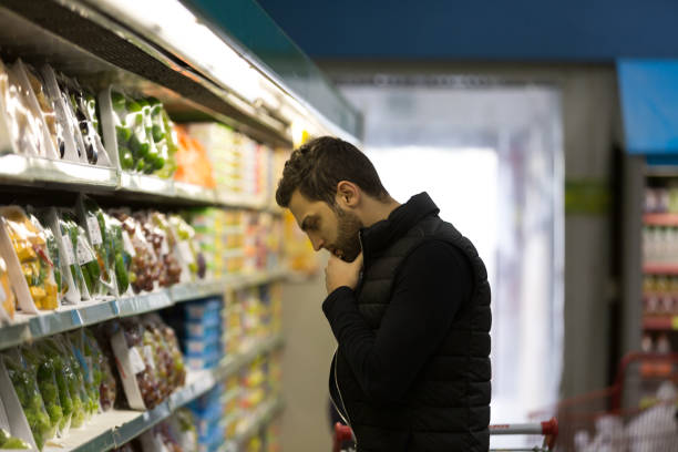 istock Attractive man shopping in a supermarket 864692440