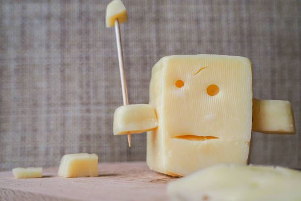 istock Funny cheese. A piece of cheese with the face. 864696854