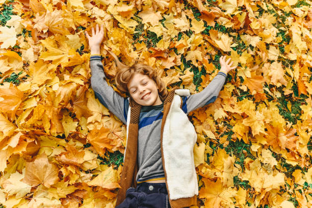 istock autumn children in the park 864697202