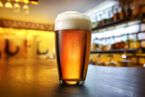 Beer in the pub Glass of lager on a wooden table in pab ale stock pictures, royalty-free photos & images