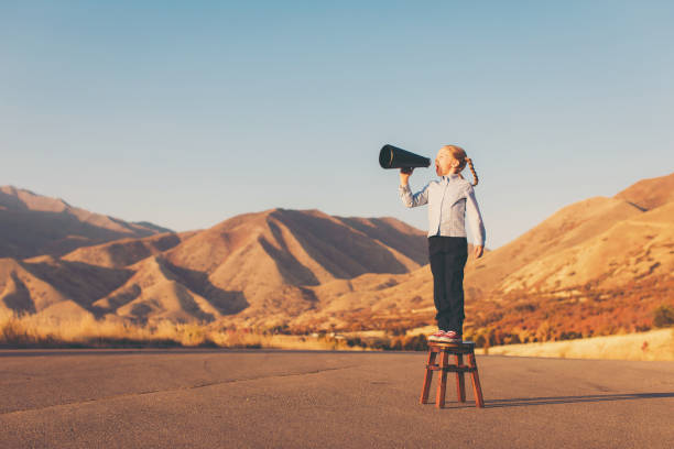 istock A Young Business Girl Uses Megaphone 864707770
