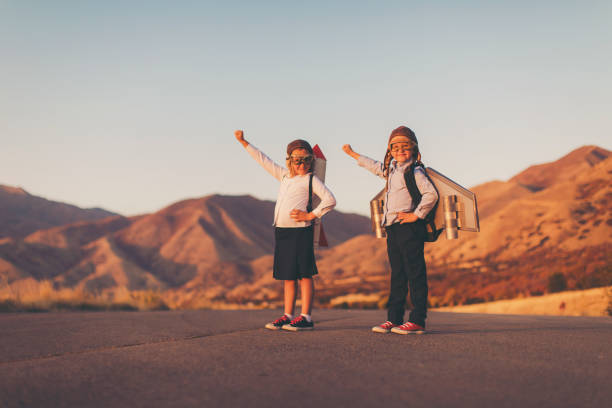 young business girls wearing rockets - teamwork occupation creativity taking off imagens e fotografias de stock