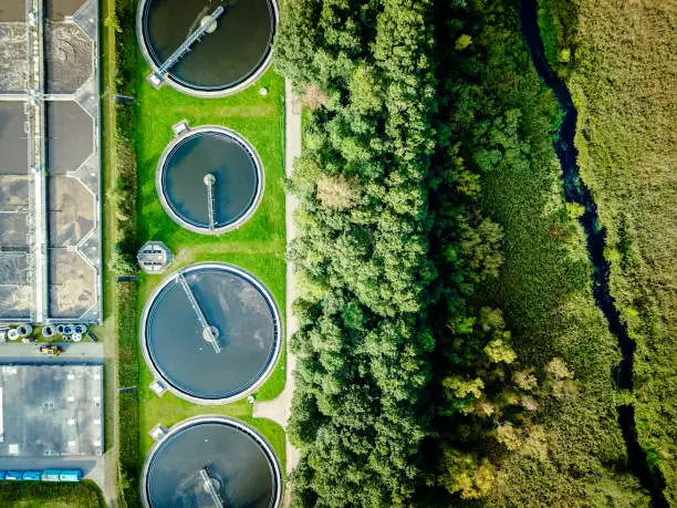 Aerial shot of sewage treatment plant placed near a river, Denmark.  Aerial view shot with drone.