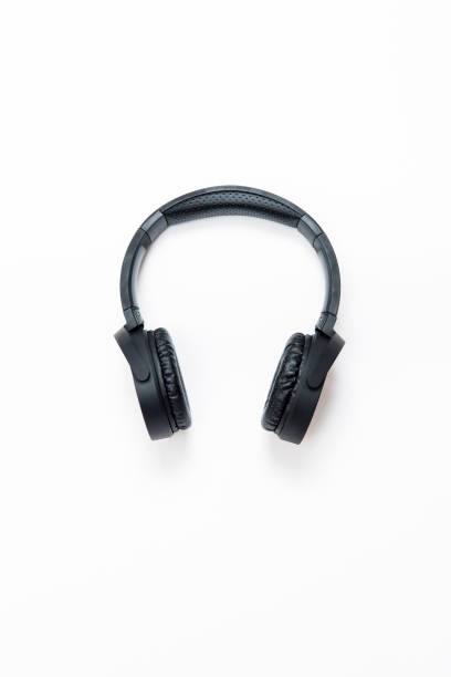 High angle view of a black wireless headphone over isolated on white. These headphones are wireless and work through bluetooth. Vertical composition. Image taken with Nikon D800 and developed from Raw format.