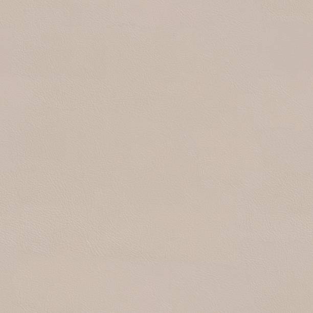istock Beige leather texture close up. Seamless square background, tile 864724324