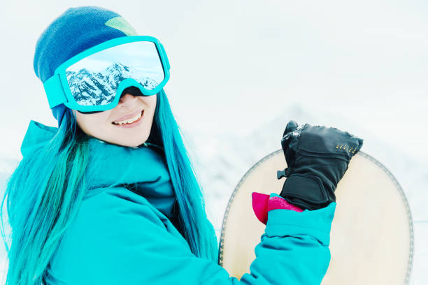 istock Woman snowboarder in protective sunglasses. 864728042